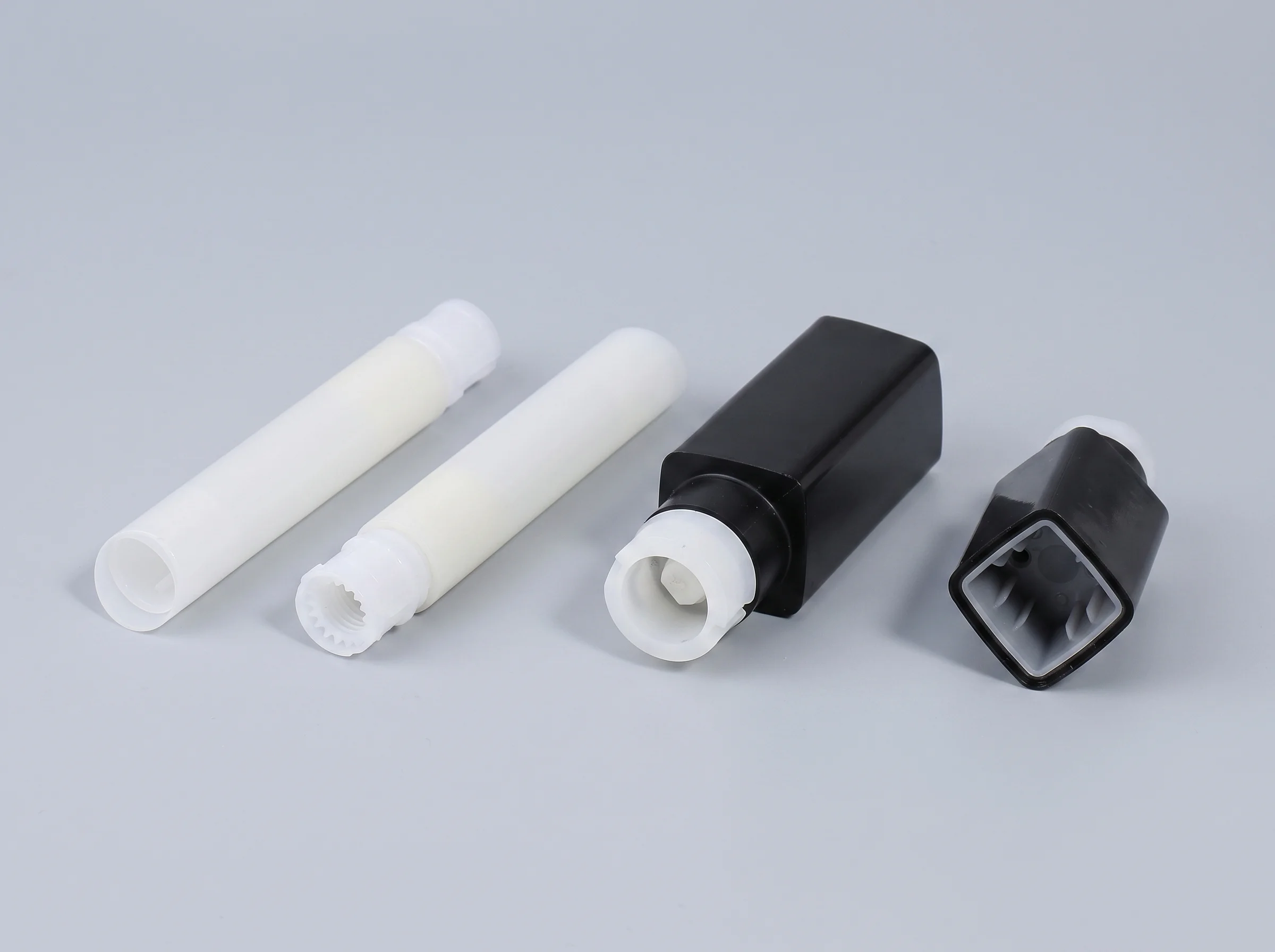 Exploded lipstick tube view showing exterior shell, cap, base, and the inner core assembly with cup, fork, and spiral